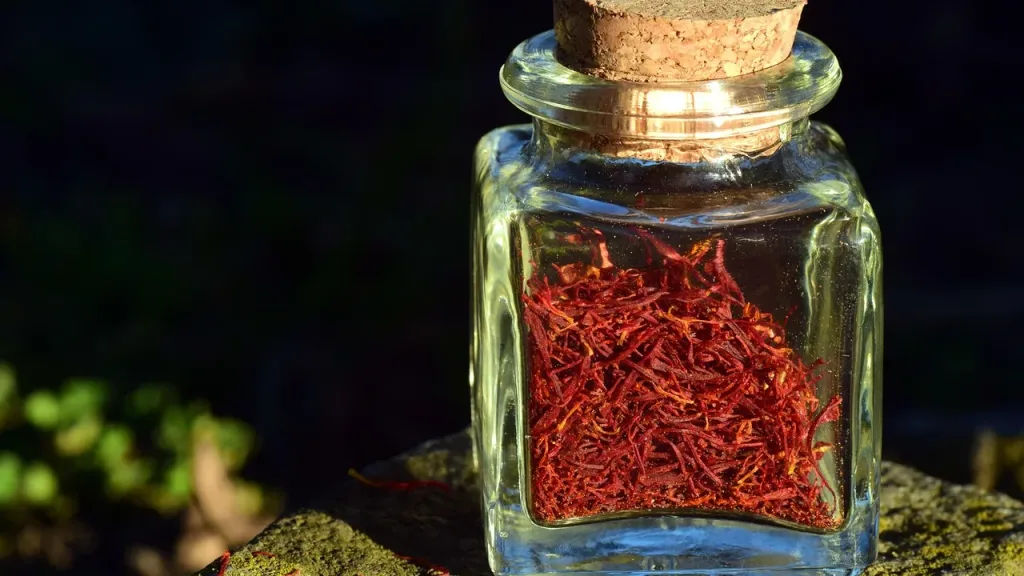 Red saffron threads in a glass jar for cooking