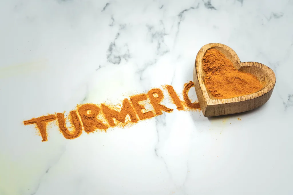 Vibrant yellow turmeric powder in a bowl for spice comparison